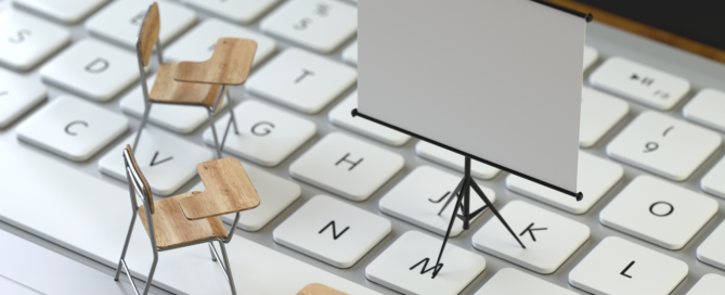 Little chairs and a presentation chart on top of a computer keyboard.