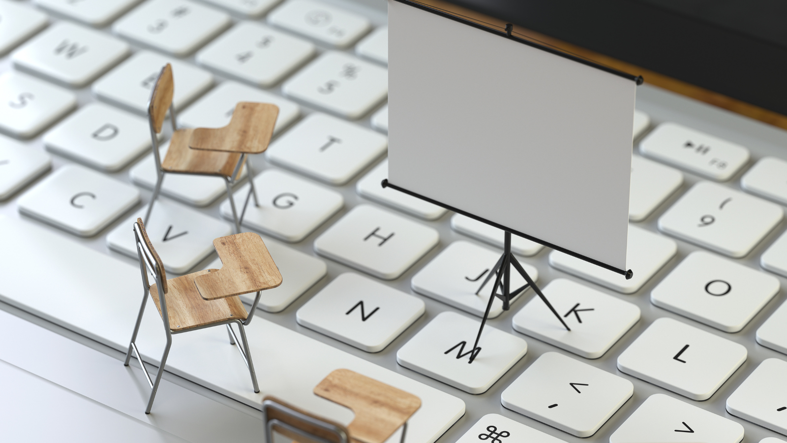 Little chairs and a presentation chart on top of a computer keyboard.