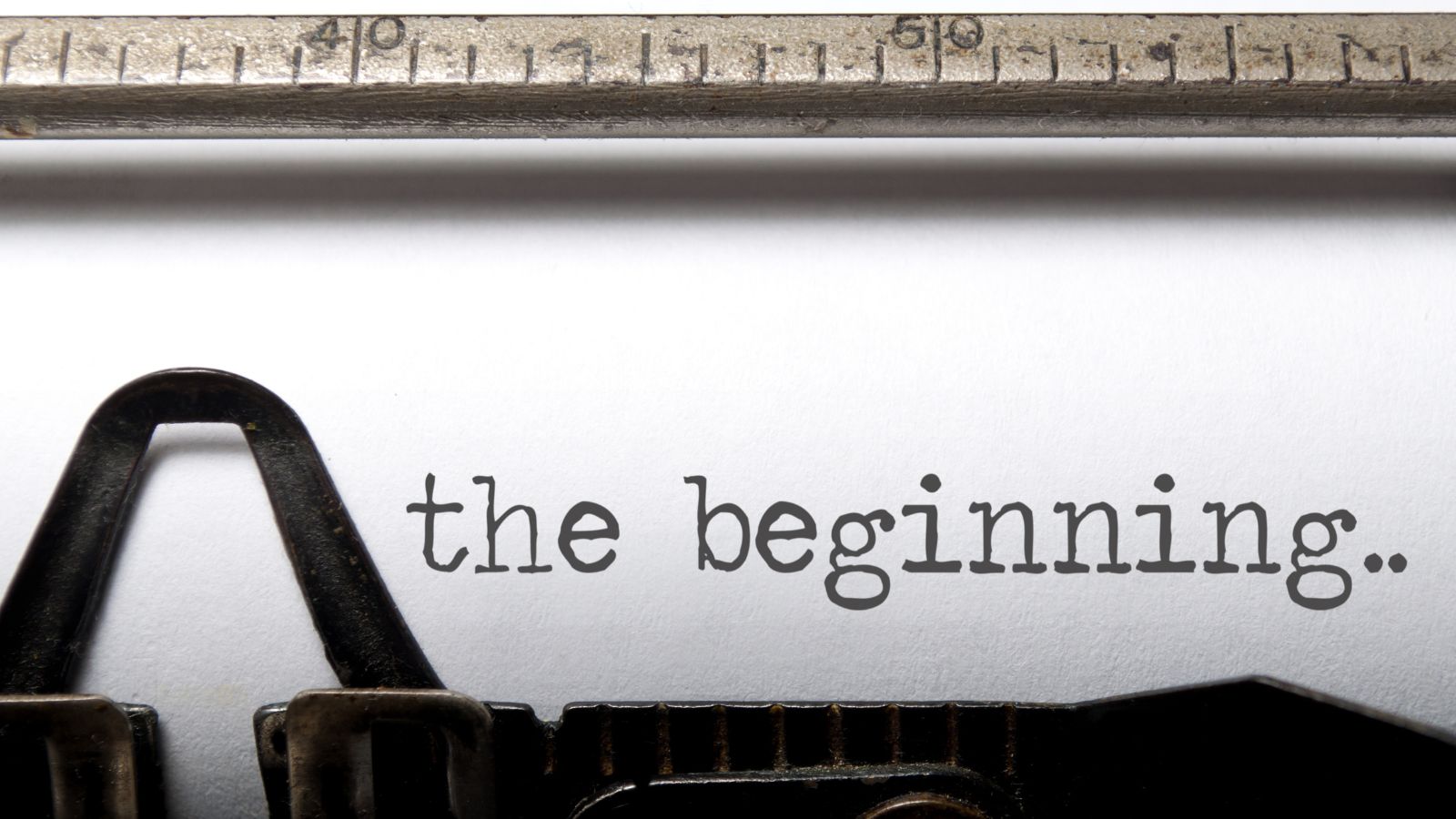 typewriter with text: 'the beginning...'