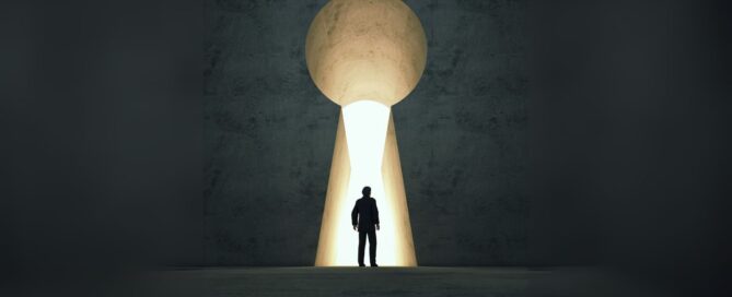 Person stands in front of large key lock with light coming through