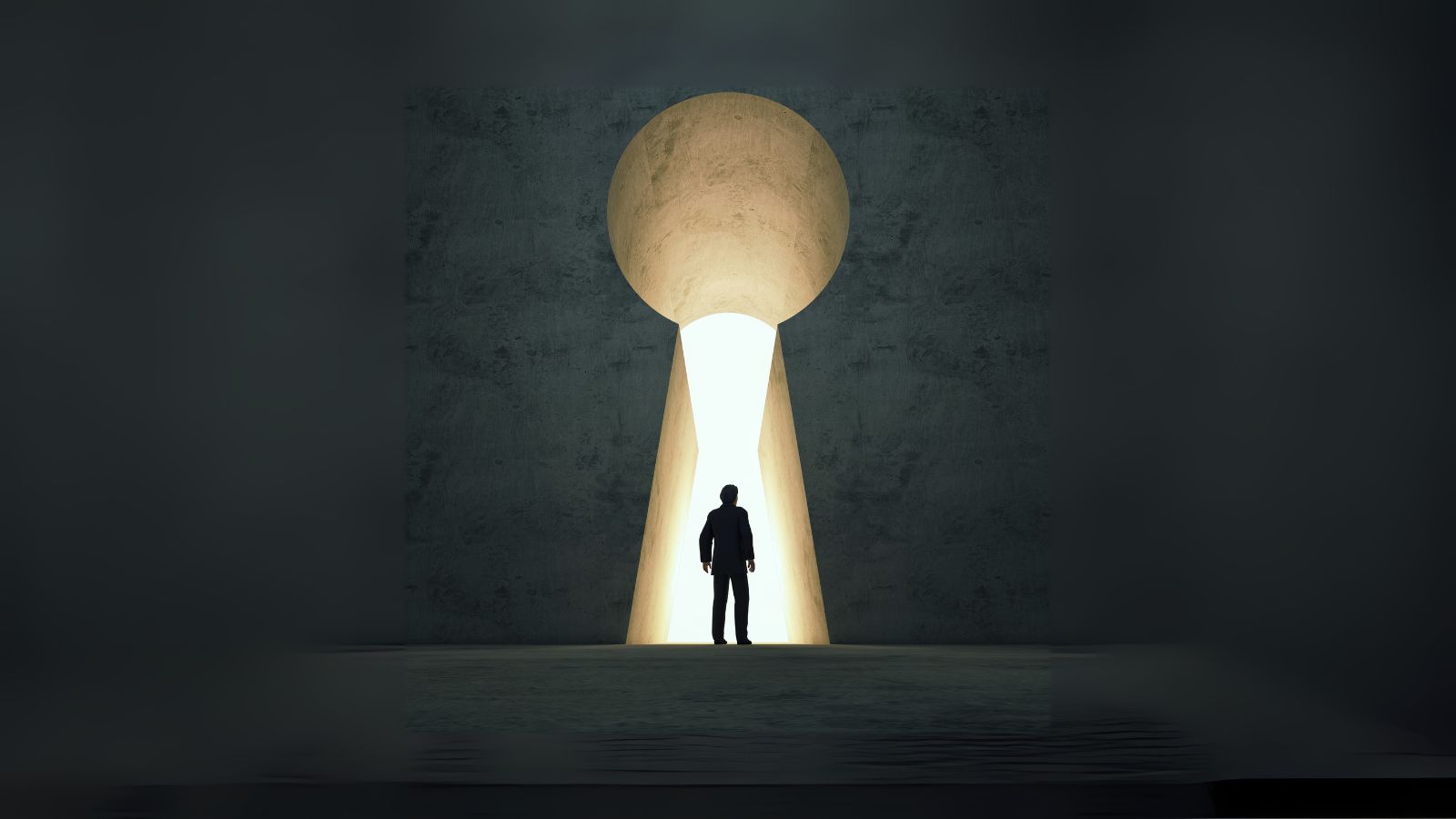 Person stands in front of large key lock with light coming through