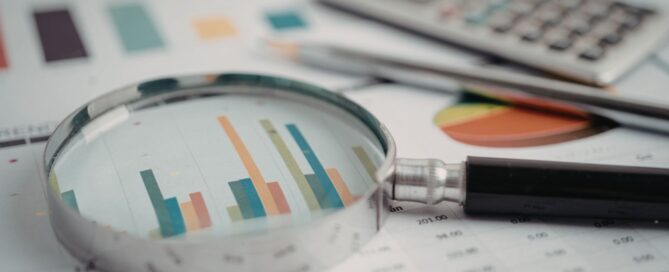 Image of magnified glass highlighting charts