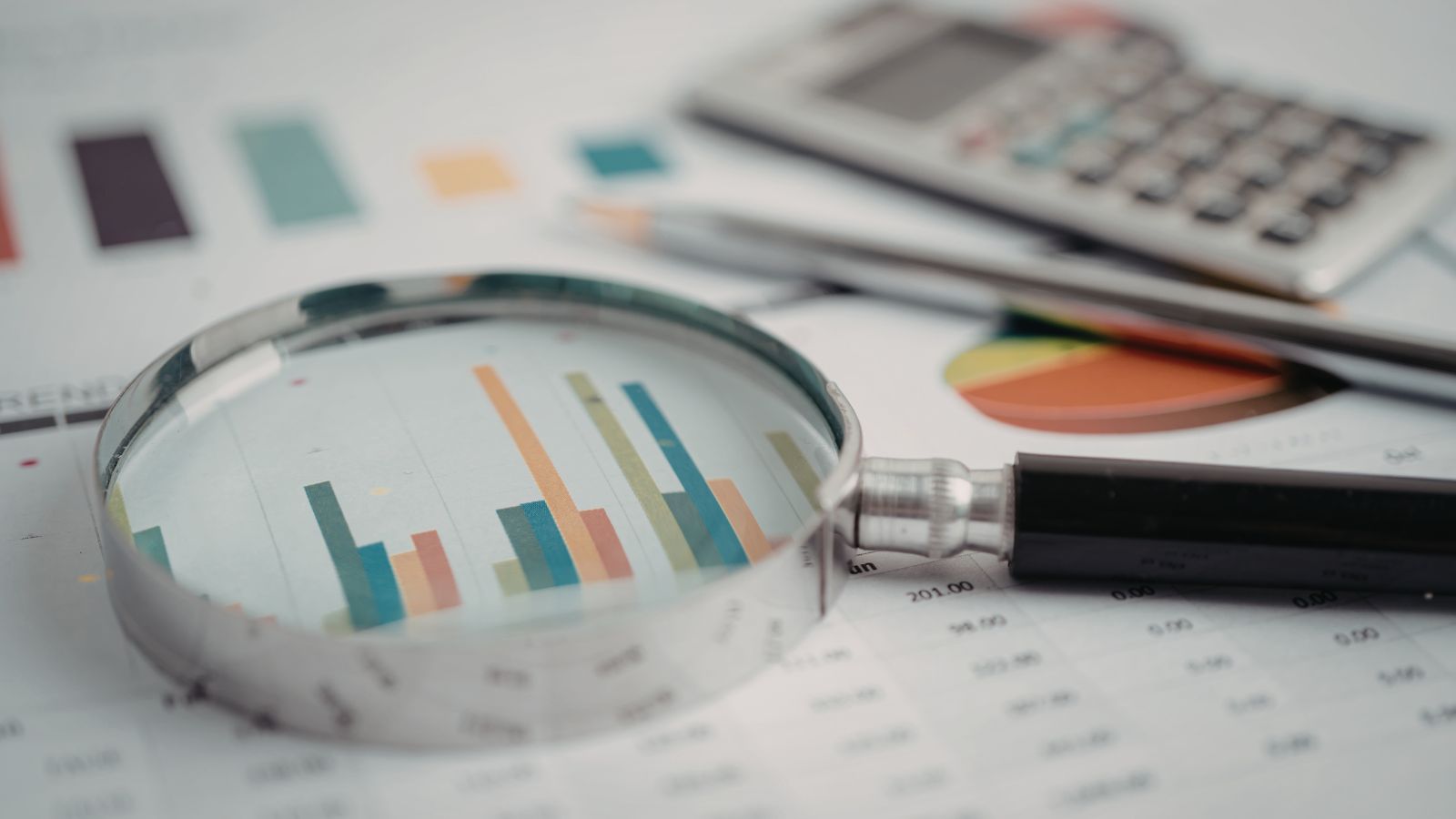 Image of magnified glass highlighting charts