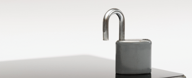 Unlocked lock on grey background