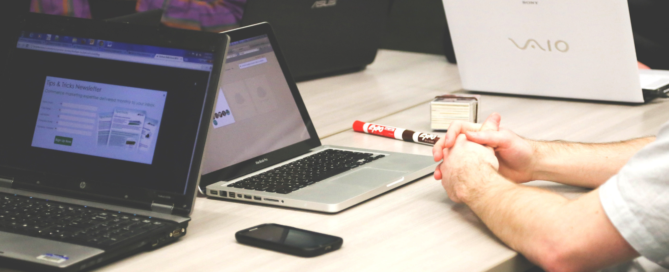 discussion at table with laptops