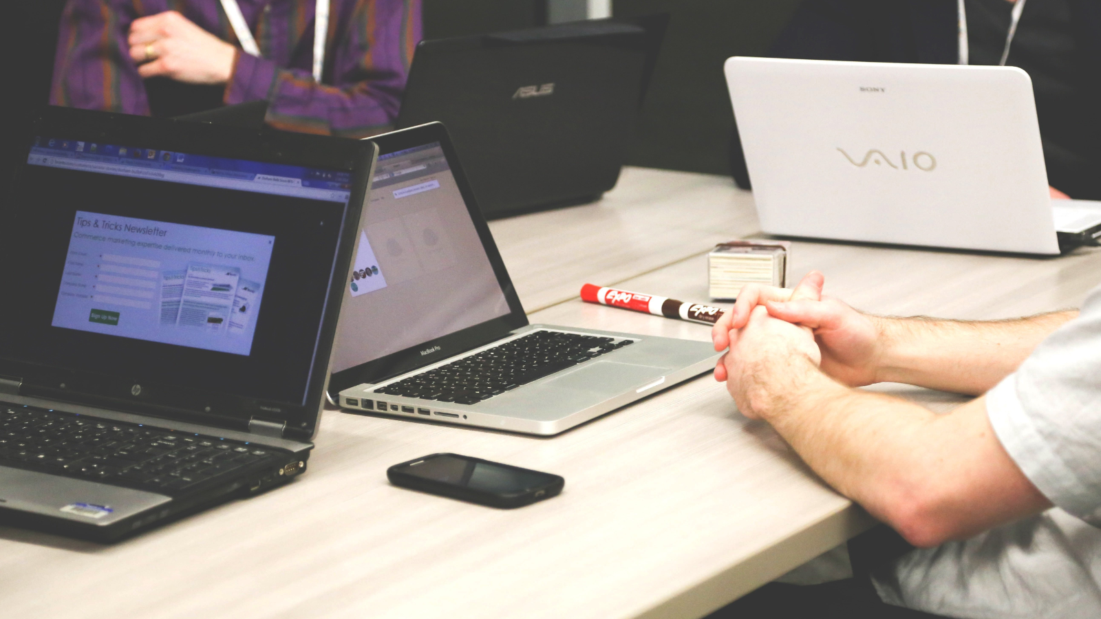discussion at table with laptops